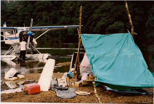 Camped on the riverbank, working on the airplane. (Chapter 3)