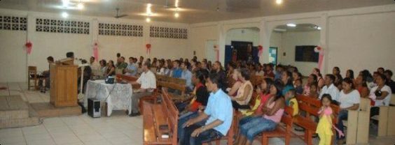 The congregation gathered for worship along the river.