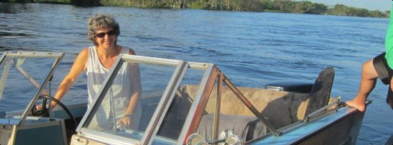 Kim at the helm of a boat on the Amazon river.